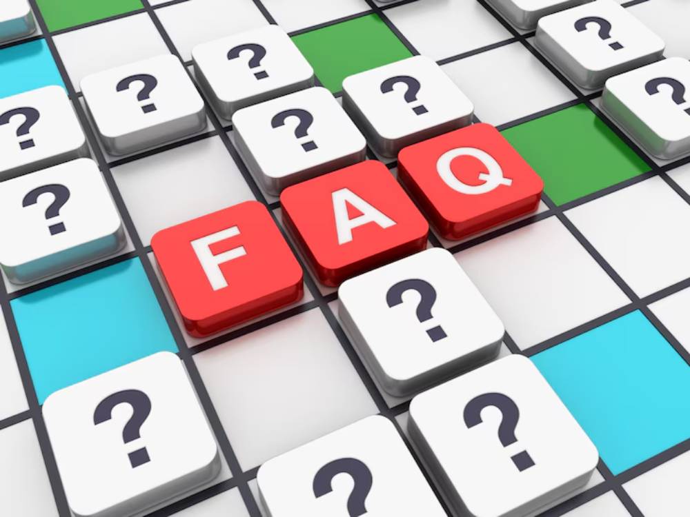 A colorful grid features a bold red 'FAQ' amidst various white tiles marked with question marks, suggesting inquiries and information.