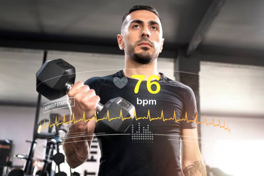 A person in a gym lifts a dumbbell, with a heart rate of 76 bpm displayed alongside workout data and a heartbeat monitor graphic.